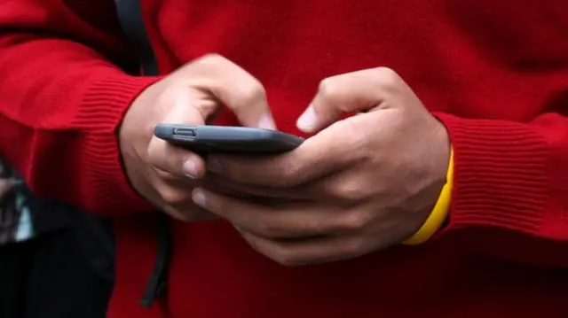 Child holds phone