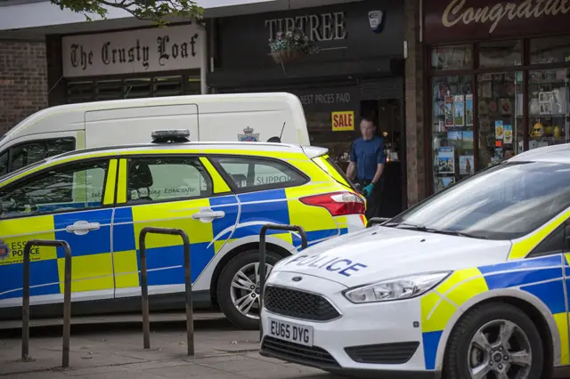 Police cars and officer outside jeweller's