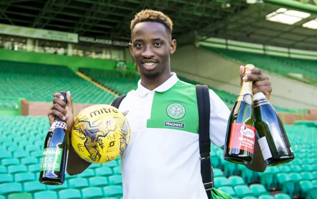 Celtic striker Moussa Dembele has three bottles of fizz and the match ball to mark his hat-trick against Rangers