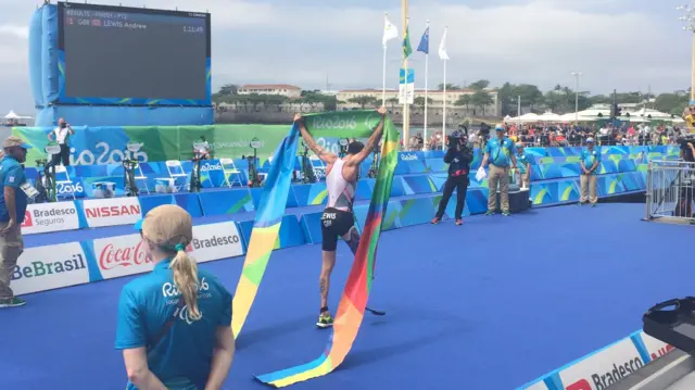 Andy Lewis crosses the line to win the PT2 triathlon at the Rio Paralympics