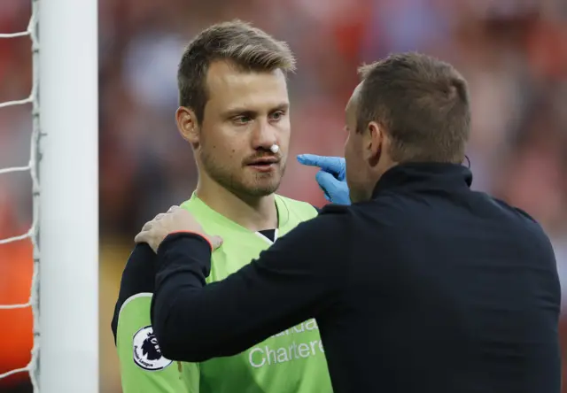 Simon Mignolet receives medical attention