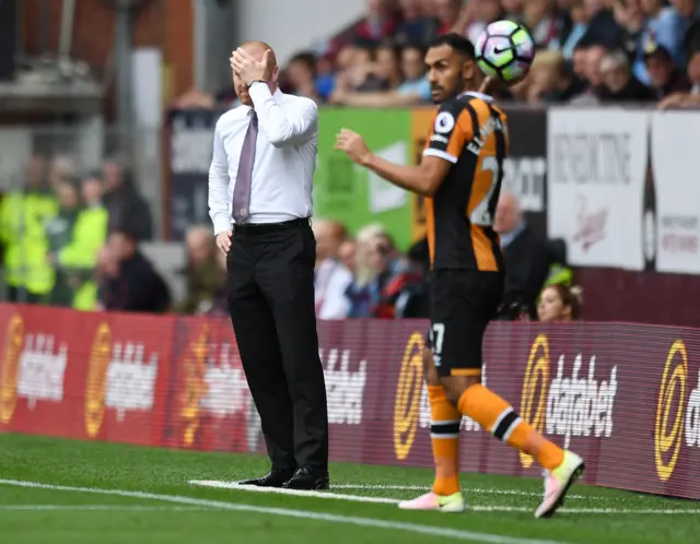 Burnley manager Sean Dyche looks on.