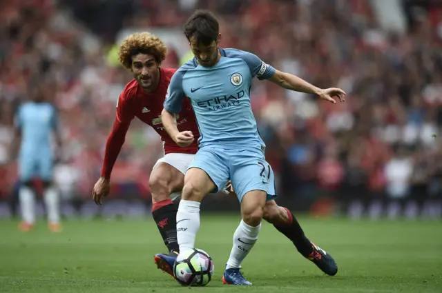 David Silva vies with Marouane Fellaini