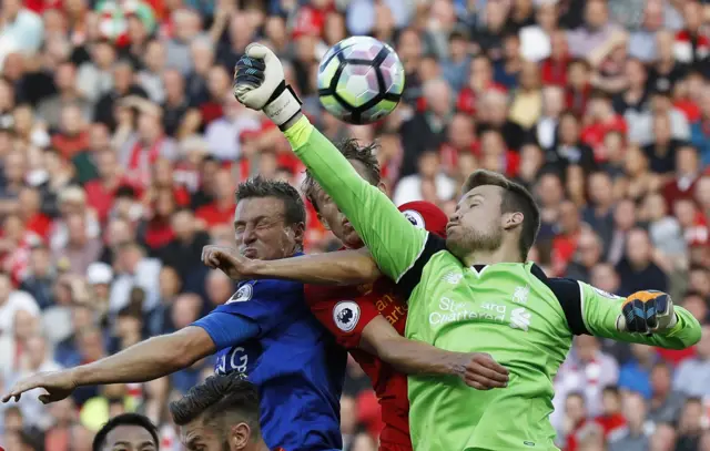 Liverpool"s Simon Mignolet and James Milner in action with Leicester City"s Robert Huth