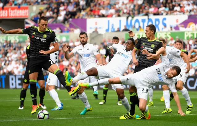 John Terry and Nemanja Matic of Chelsea battle with Jordi Amat, Leroy Fer and Gylfi Sigurdsson of Swansea