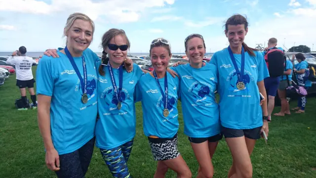 Five Great North Run finishers with their medals