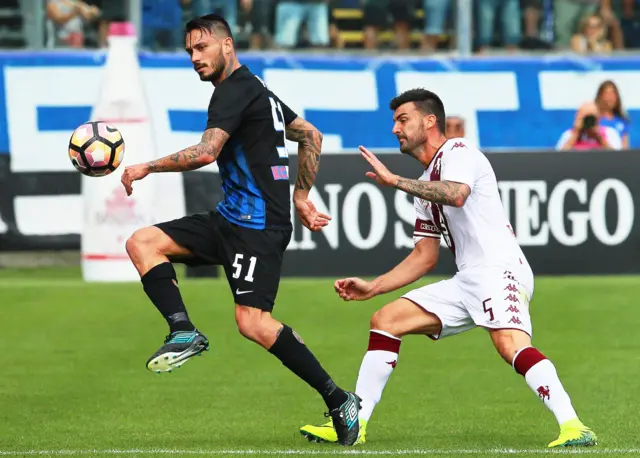 Atalanta's Mauricio Pinilla (L) in action against Torino's Cesare Bovo