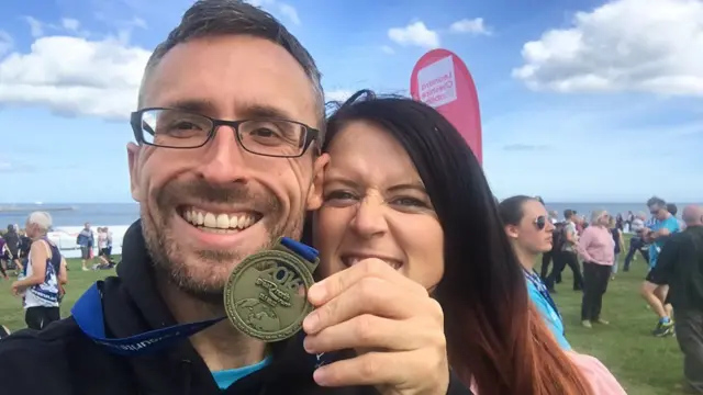 A Great North Run finisher with their medal