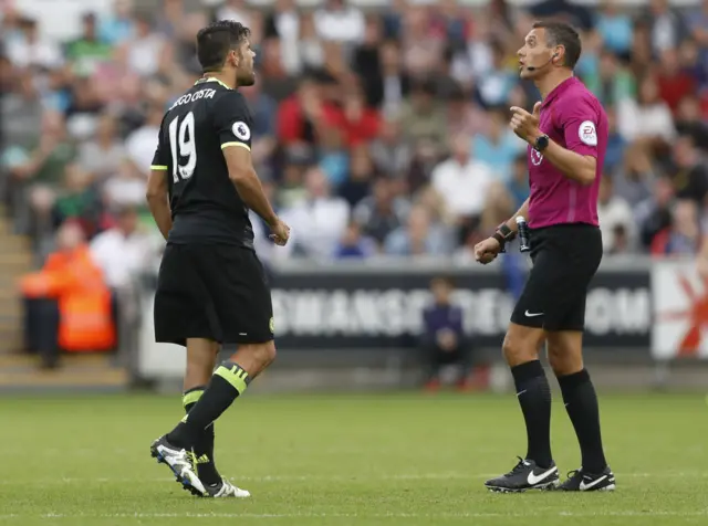 Ref Andre Marriner talks to Costa