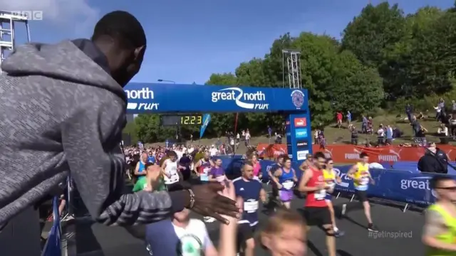 David Rudisha high fives runners at the start of the Great North Run