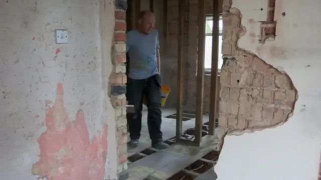 Paul Sayer, in a house that's being renovated