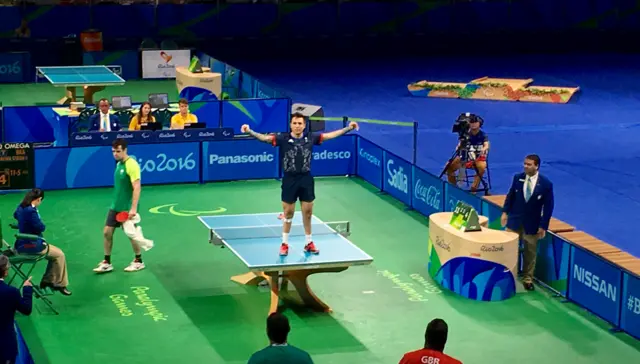 Will Bayley stands on the table to celebrate table tennis gold at the Rio Paralympics