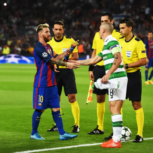 Lionel Messi and Scott Brown shake hands before kick-off