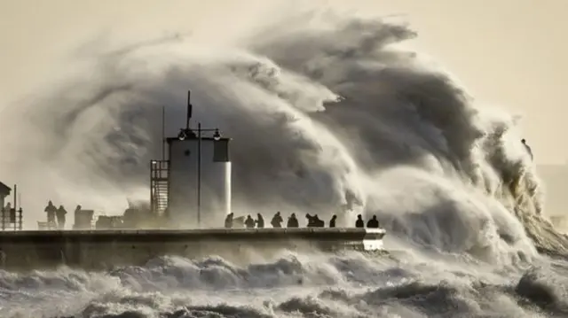 An enormous wave crashes over Porthcawl harbour