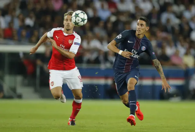 Nacho Monreal and Angel Di Maria fight for the ball