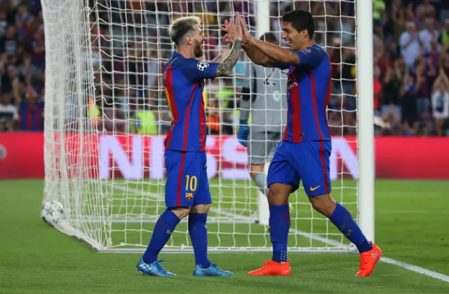 Lionel Messi and Luis Suarez celebrate