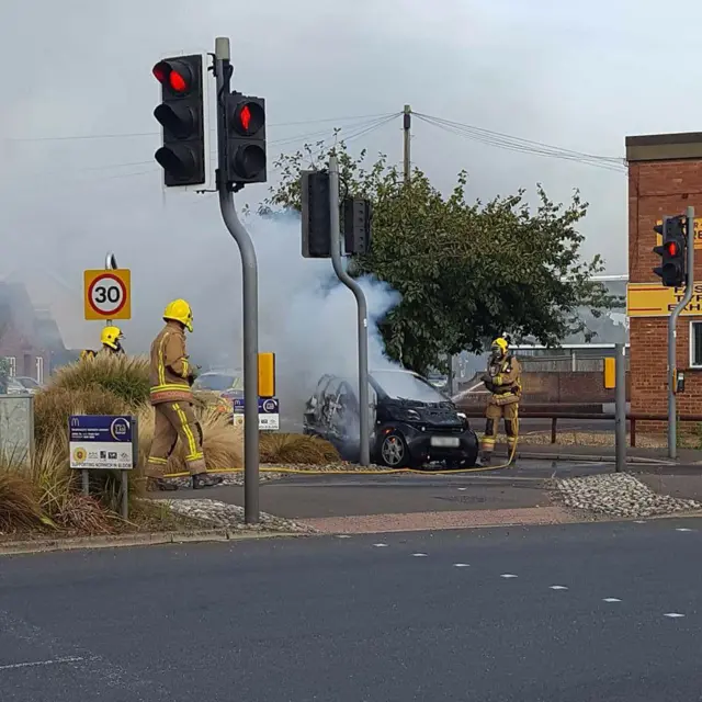 Fire crews using hose jets to extinguish the fire