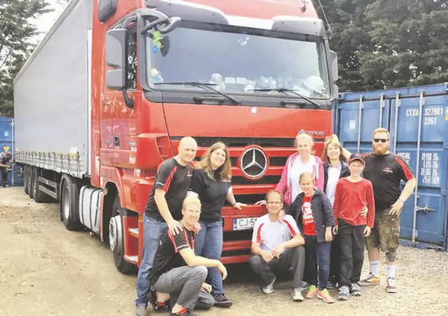 South African Christians in Norwich loading up a 10-ton truck with aid for churches in poverty-stricken areas of Romania, surrounded by storage containers