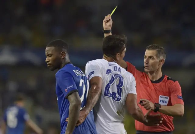 Leonardo Ulloa receives a yellow card