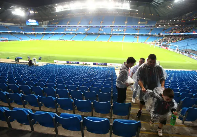 Fans leaving the Etihad Stadium after Man City-Borussia Moenchengladbach was called off