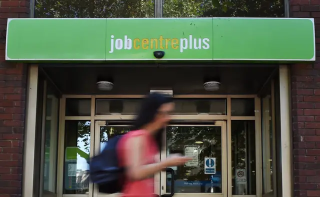 Job Centre Plus sign and passerby