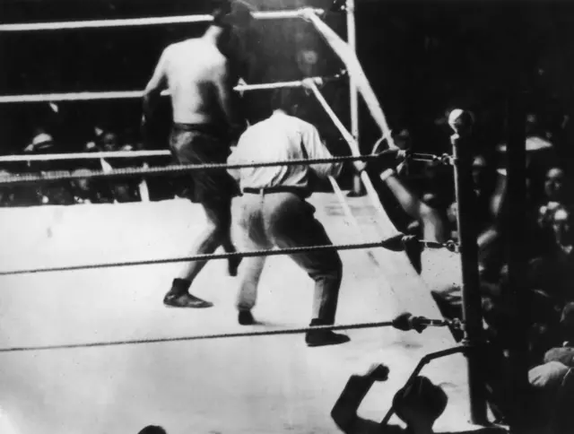 Jack Demsey is knocked out of the ring