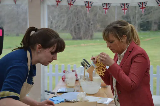 Kate Barmby with Mel Giedroyc, who's holding one of the lacy pancakes