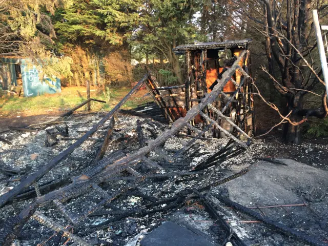 Fire debris and ash, all that remains of a timber-framed hall destroyed in a fire