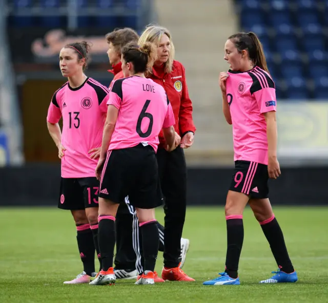 Anna Signeul consoles her players after a defeat by Iceland