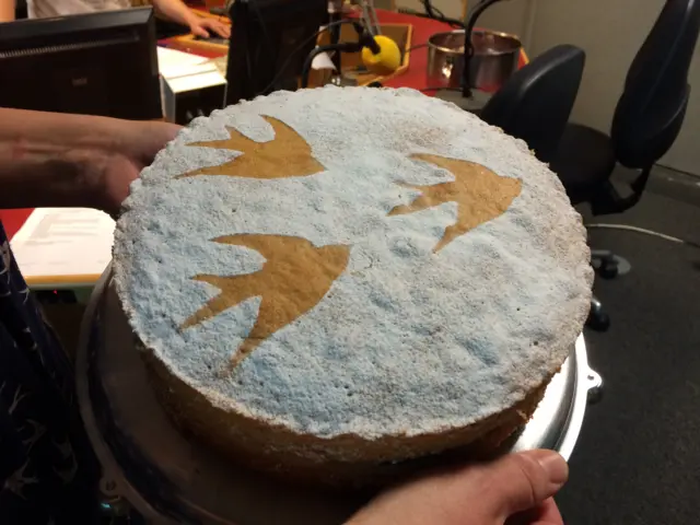 A close-up of Kate's sponge cake, with icing sugar and bird design