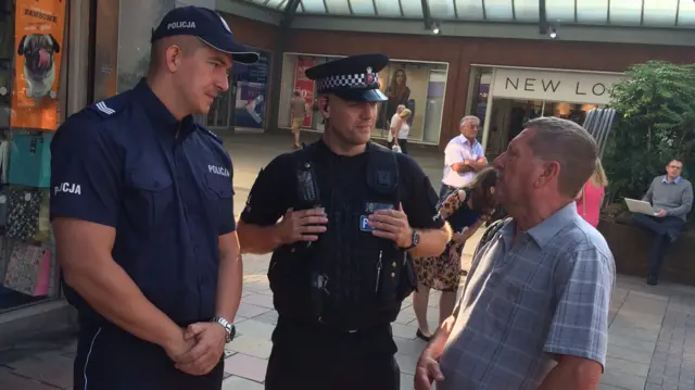 Polish police officer on patrol with his British counterpart in Harlow