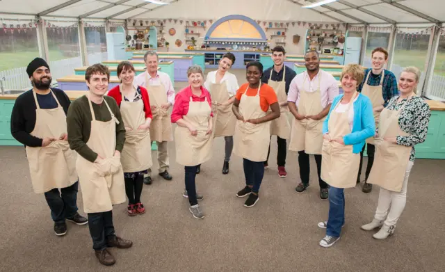 Kate, third from left, with all the other contestants - all wearing aprons - in the Bake Off tent