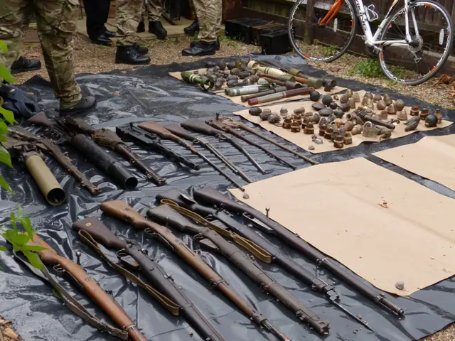 rifles, grenades and other military memorabilia laid outside