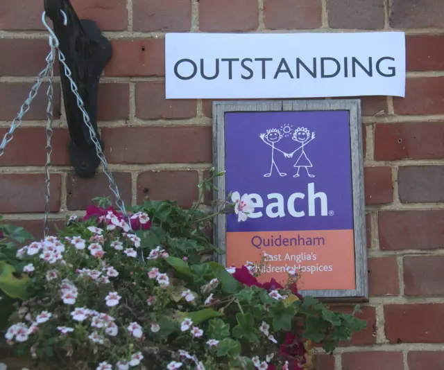 Sign for the Hospice with 'outstanding' rating above