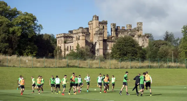 The Celtic players jog around their Lennoxtown training base