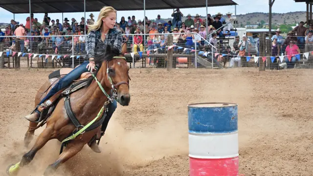 A cowgirl in action at a rodeo