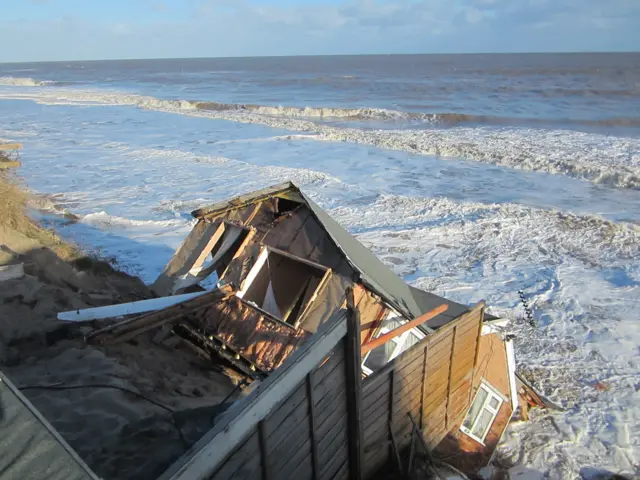 One of the bungalows that fell into the sea during the tidal surge