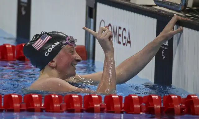 American McKenzie Coan celebrates taking the gold in the S7 100m freestyle