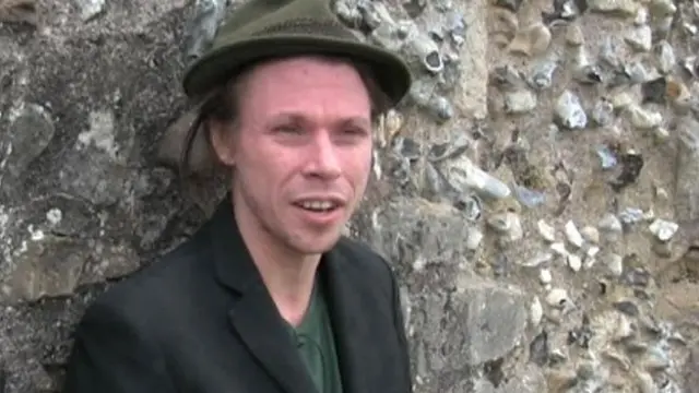 Lauri Love leaning against a wall