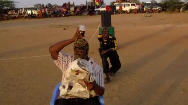 Al-Shabab fighters playing a "glass on head" game, Somalia