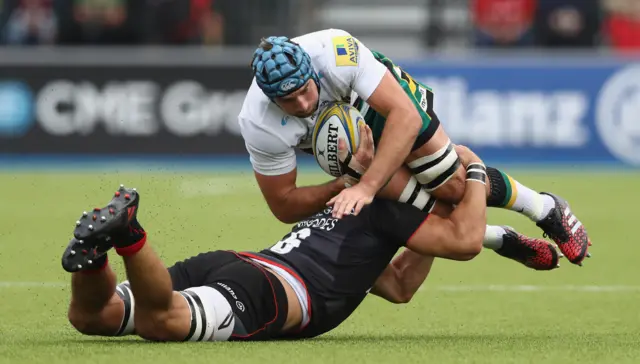 Michael Paterson of Northampton is tackled by Michael Rhodes