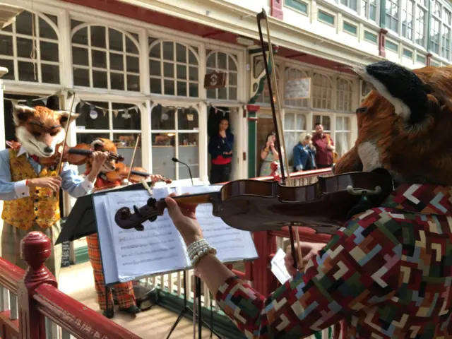 Musicians in fox costumes