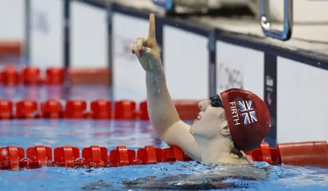 Bethany Firth celebrates winning a third gold medal