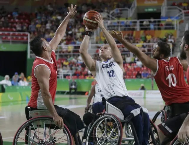 Ian Sagar of Britain tries to score past Ozgur Gurbulak of Turkey