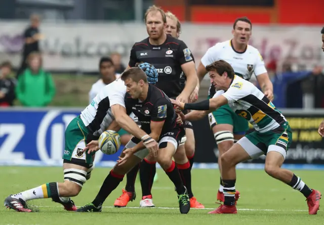 Richard Wigglesworth passes the ball as he is tackled