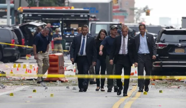 New York Gov. Andrew Cuomo, right, walks from the scene of an explosion on West 23rd street in Manhattan"s Chelsea neighborhood, in New York, Sunday, 18 September 2016,