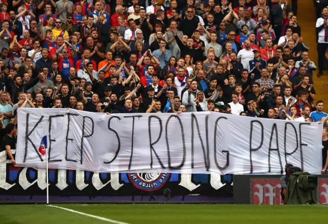 Crystal palace fans show their support for injured Pape Souare