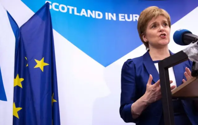 Nicola Sturgeon before banner Scotland in Europe and EU flag