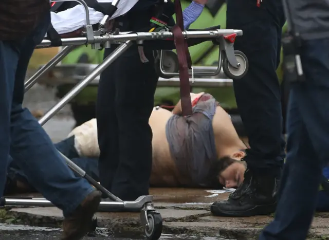 Ahmad Khan Rahami is taken into custody after a shootout with police Monday, Sept. 19, 2016, in Linden, N.J