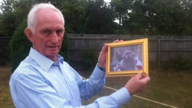 Peter Bryson with a photo of Merlin